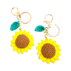 Suzie's Sunshine Dolls handmade crochet sunflower keychains with brown centers and yellow petals, featuring green leaves and gold clasps.