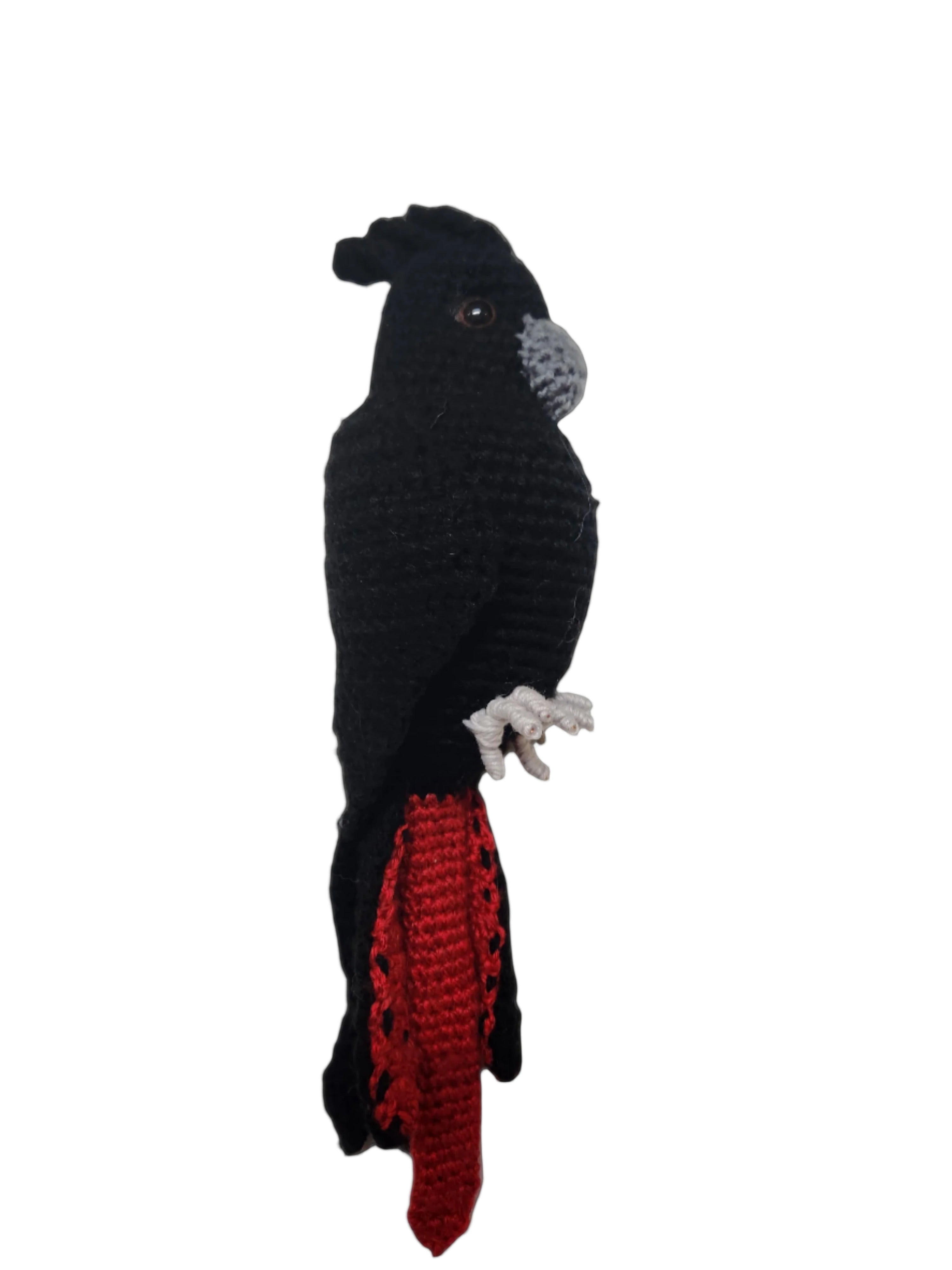 Suzie's Sunshine Dolls black cockatoo crocheted bird with red tail accents and wire feet.