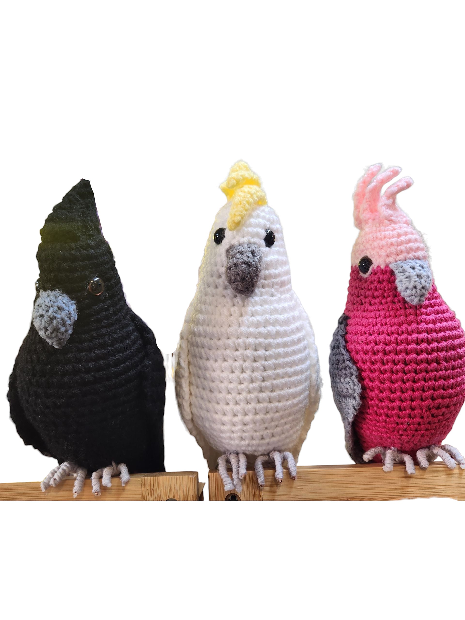 Suzie's Sunshine Dolls: crocheted Black Cockatoo, white Sulphur-Crested Cockatoo, and pink Galah with wire feet.
