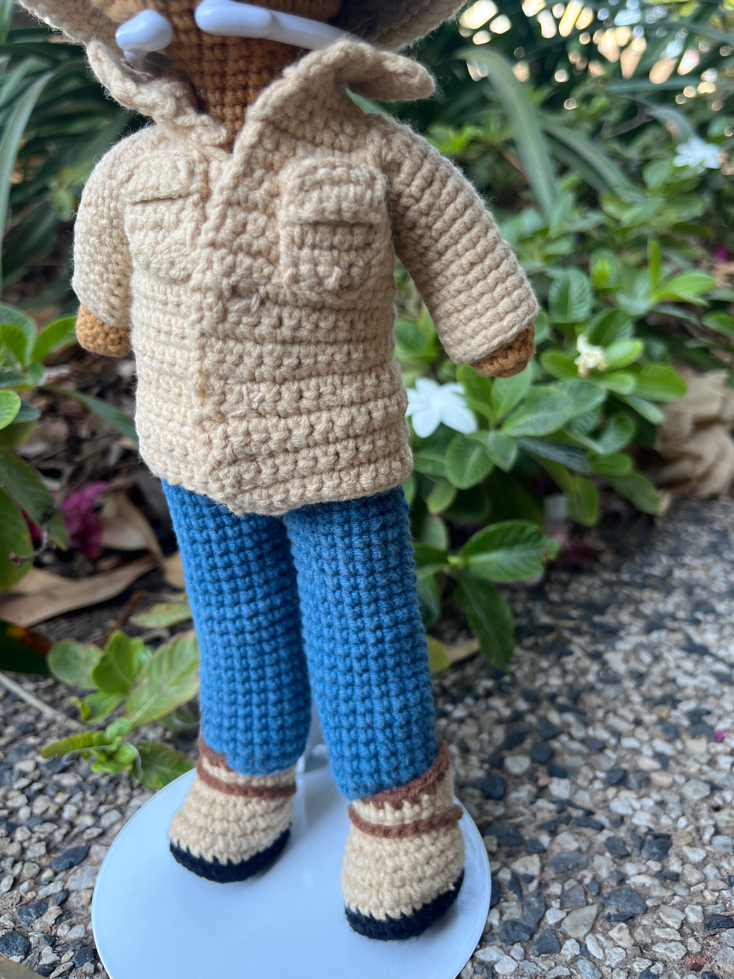 Suzie's Sunshine Dolls crocheted cowboy doll in tan jacket, blue jeans, and boots with a wide-brimmed hat.