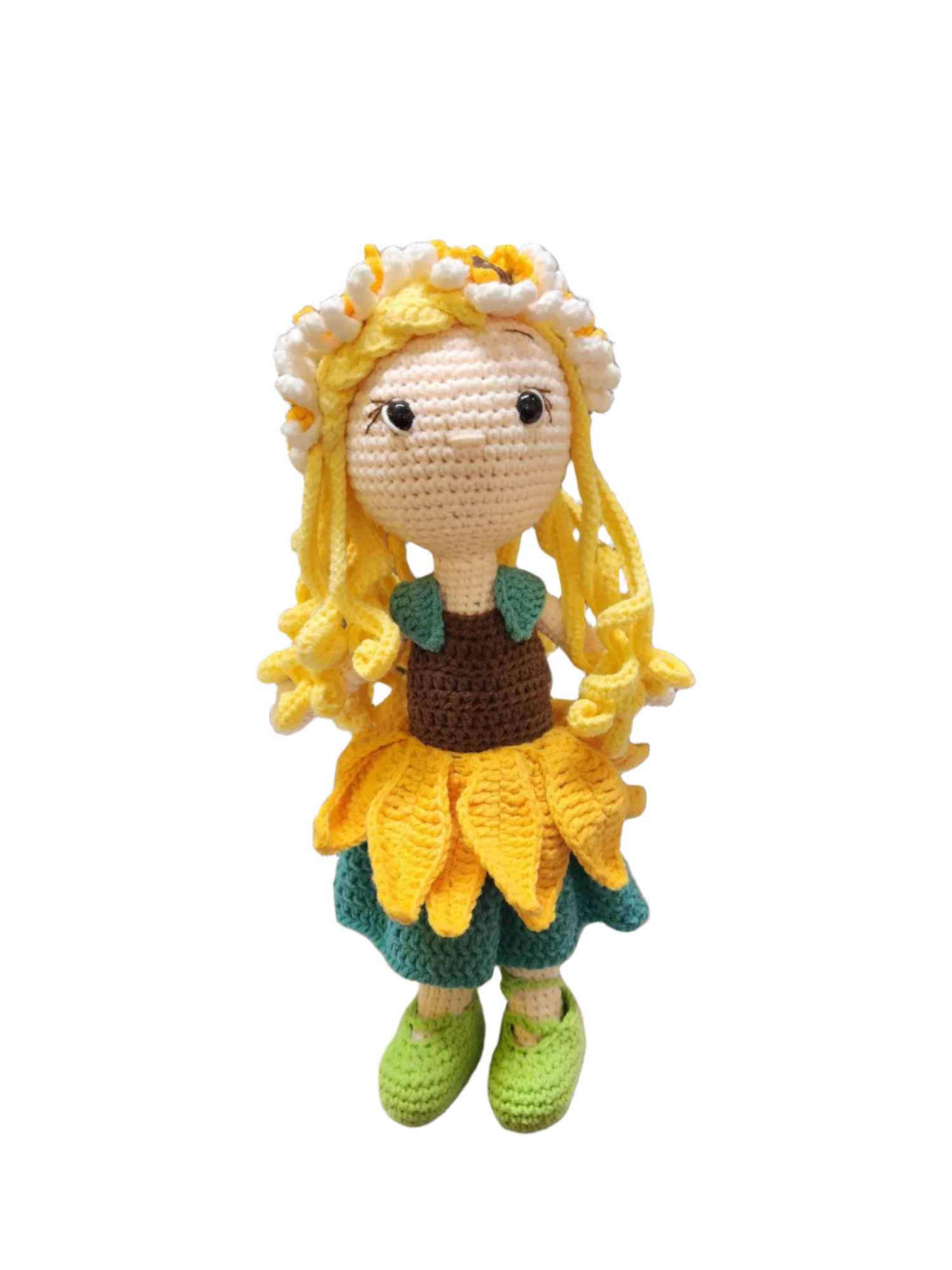 Suzie's Sunshine Dolls Daisy, a crocheted doll with golden yarn hair, wearing a sunflower skirt, green shoes, and a floral crown.