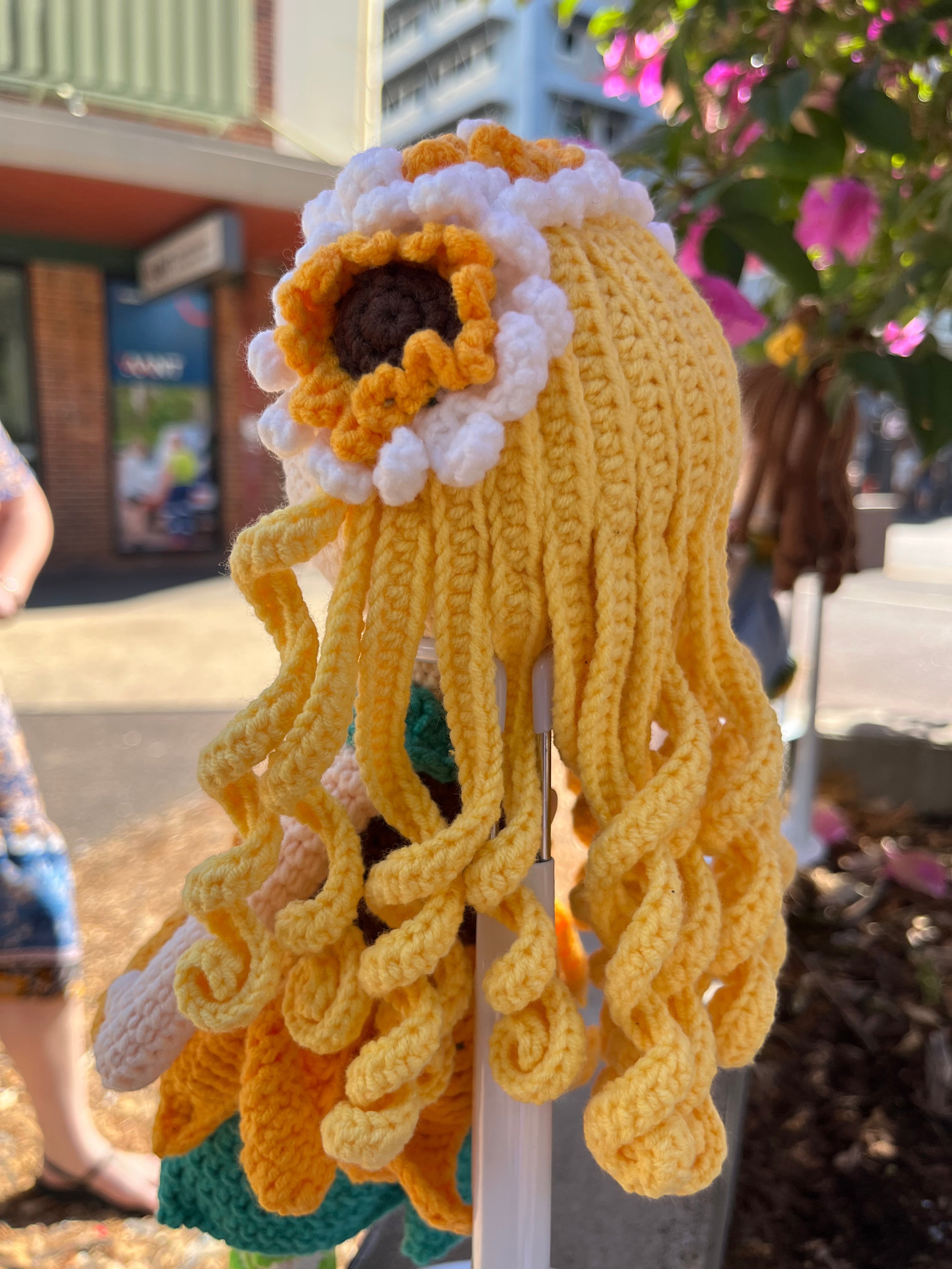 Suzie's Sunshine Dolls Daisy doll with yellow yarn hair, sunflower skirt, and floral crown. Handcrafted.