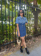 Suzie's Sunshine Dolls denim dress with puff sleeves and a collared neckline, worn by a smiling woman with sunglasses.
