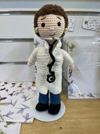 Suzie's Sunshine Dolls handmade crochet doctor doll in white coat, blue pants, and black shoes, with stethoscope and mask.