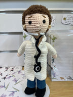 Suzie's Sunshine Dolls Doctor Doll, a crocheted figure in a white coat, blue pants, and black shoes, with a stethoscope and mask.