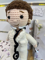 Suzie's Sunshine Dolls Doctor Doll, a crocheted figure in a white coat with a stethoscope and mask, approx. 28-30cm tall.