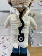 Suzie's Sunshine Dolls Doctor Doll, a crochet toy with a white coat, blue pants, and stethoscope.