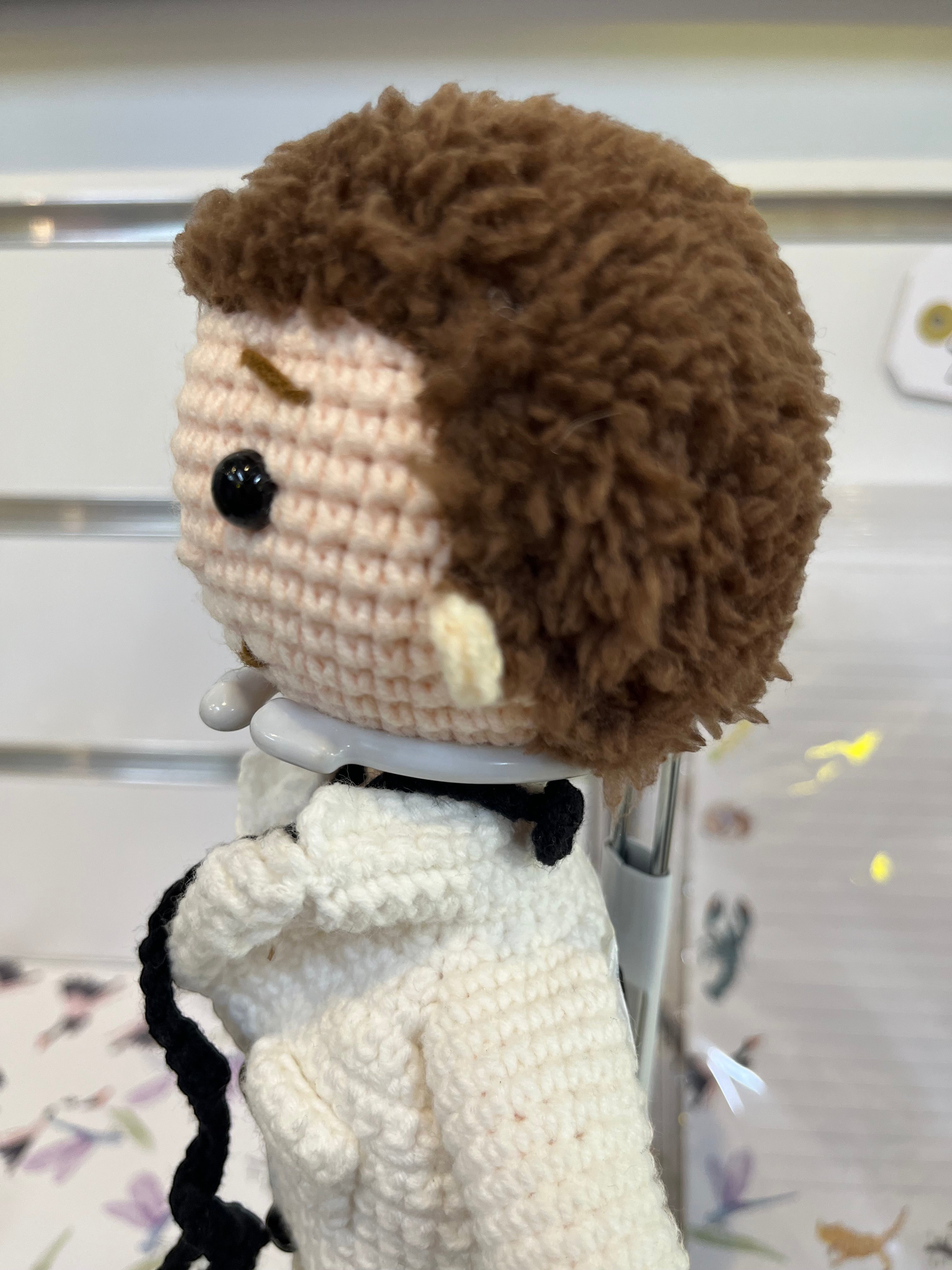 Suzie's Sunshine Dolls Doctor Doll, a crochet toy with brown hair, wearing a white coat, blue pants, and a black stethoscope.