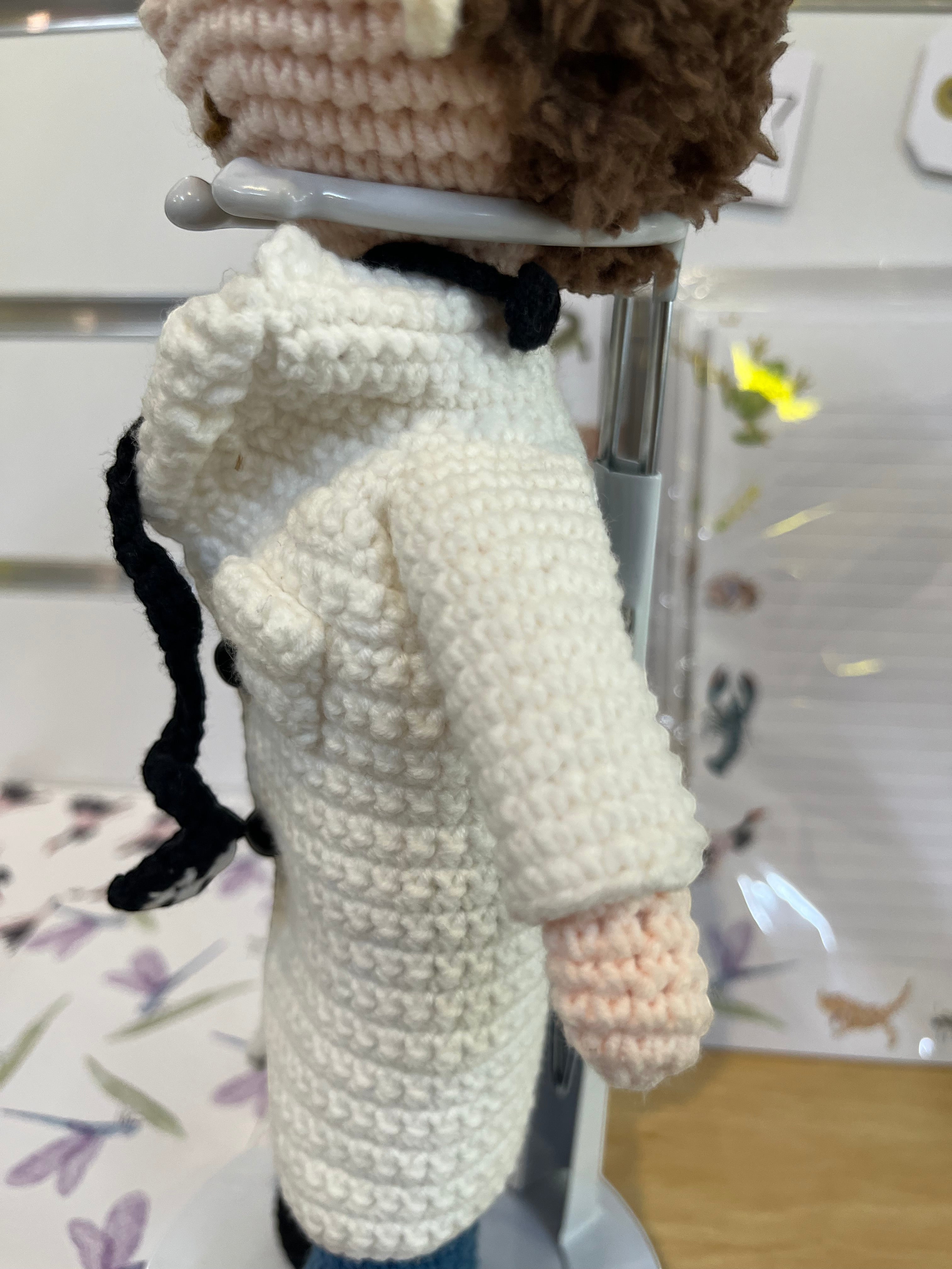 Suzie's Sunshine Dolls Doctor Doll, a crochet toy wearing a white coat, blue pants, and a stethoscope.
