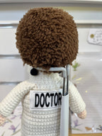 Suzie's Sunshine Dolls Doctor doll, handmade crochet, white coat, blue pants, stethoscope, face mask, brown hair.