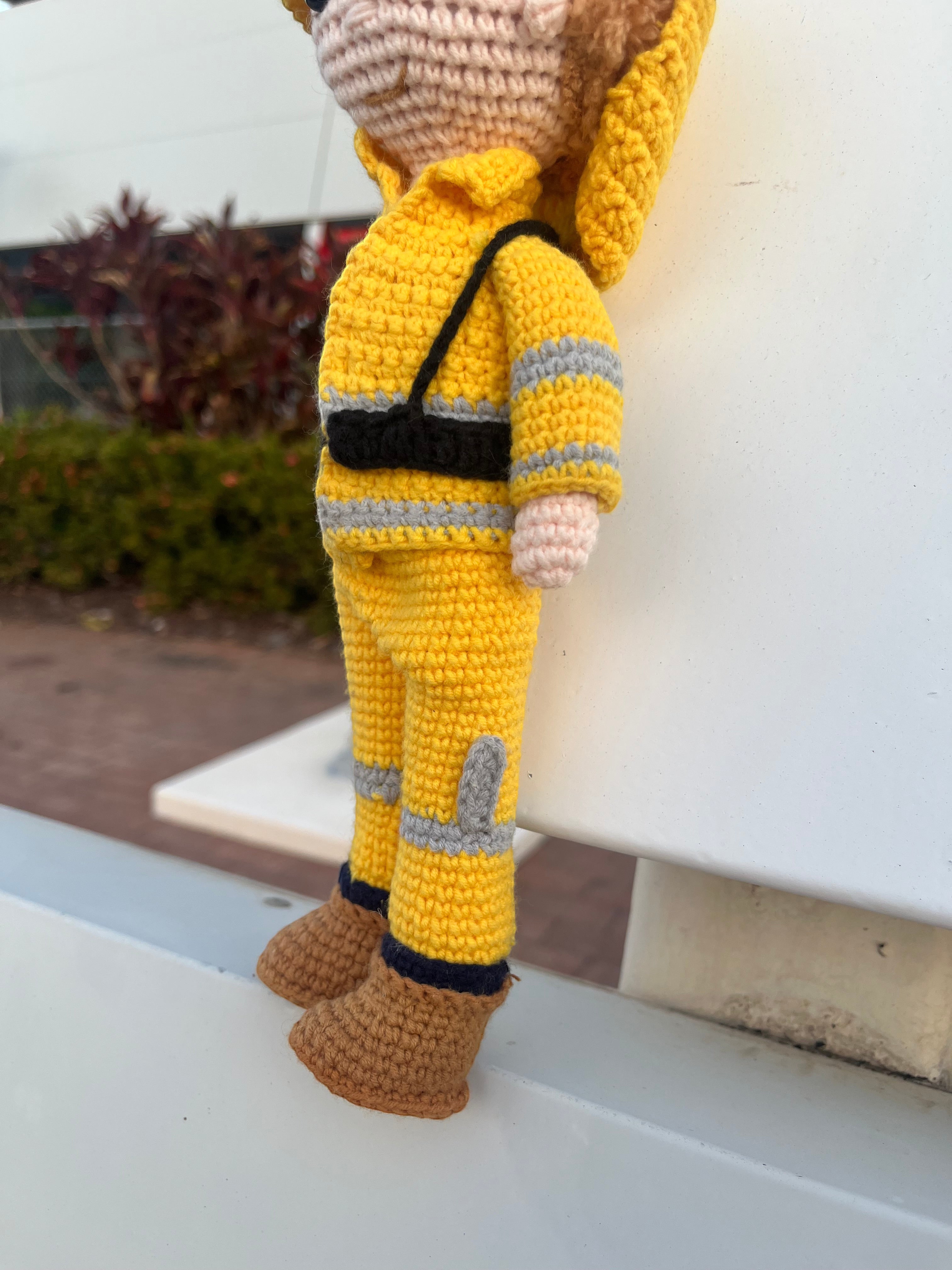 Suzie's Sunshine Dolls handmade crocheted yellow firefighter doll with reflective stripes and brown boots.