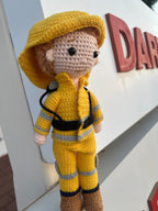 Suzie's Sunshine Dolls handmade yellow crocheted firefighter doll with reflective stripes and brown boots.
