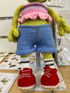 Suzie's Sunshine Dolls Frieda the Frog crochet doll with pink, purple, and yellow striped top, blue denim shorts, and red sneakers.