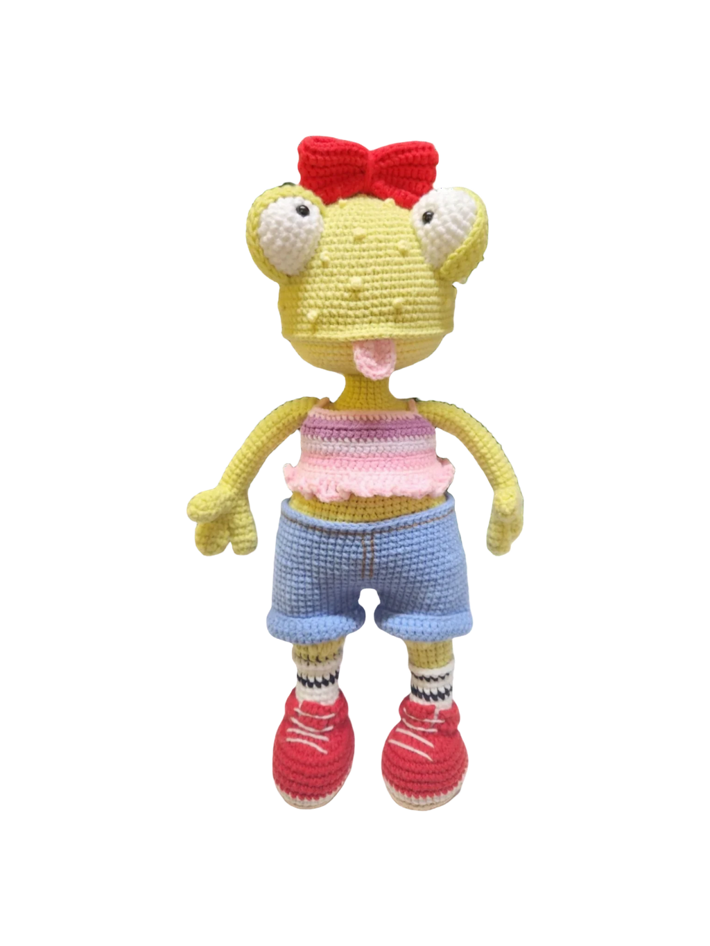 Suzie's Sunshine Dolls Frieda the Frog, a yellow crochet doll with big eyes, red bow, pink crop top, blue shorts, striped socks, and red sneakers.