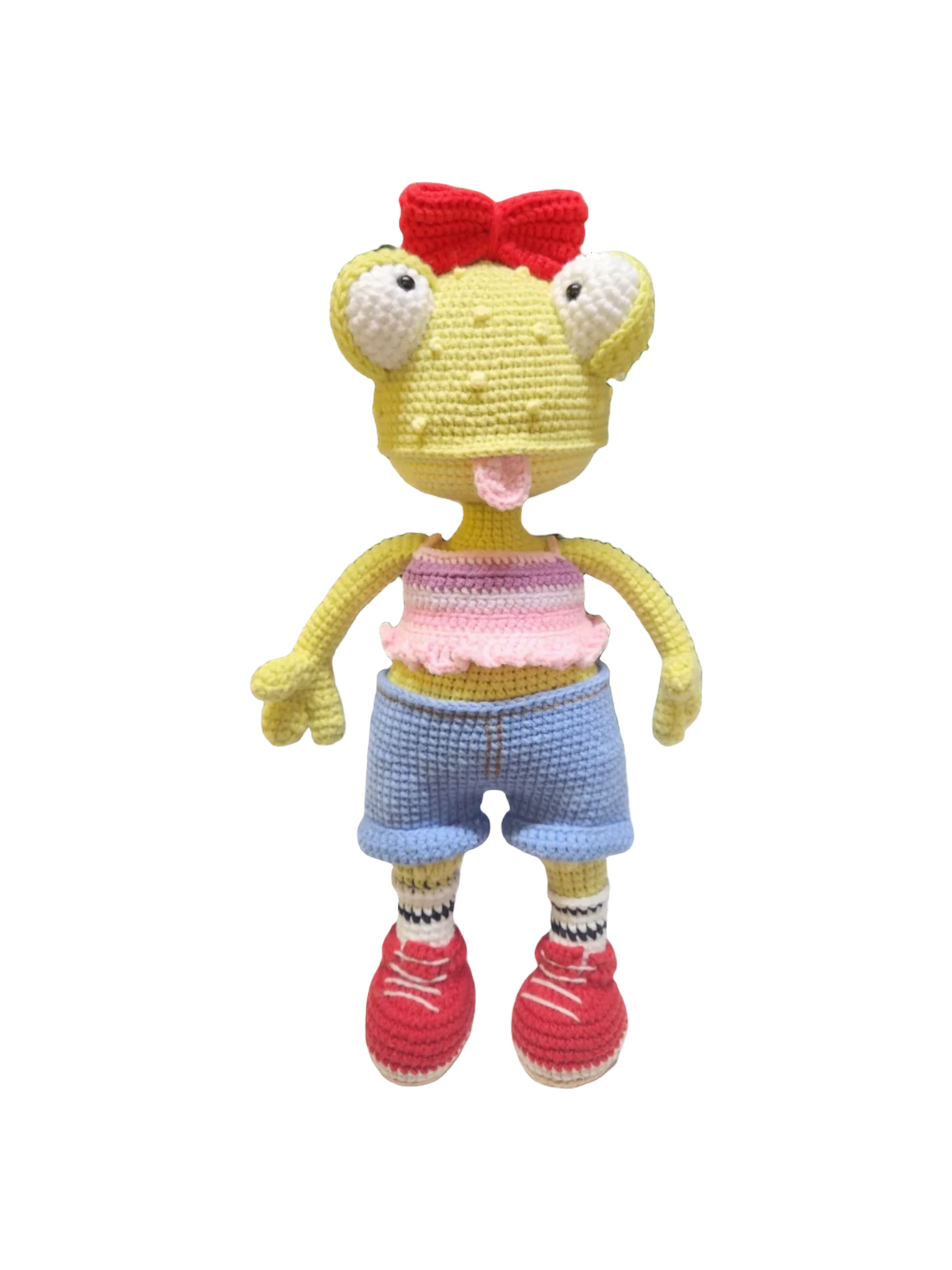 Suzie's Sunshine Dolls Frieda the Frog, a yellow crochet doll with big eyes, red bow, pink crop top, blue shorts, striped socks, and red sneakers.