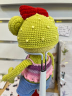 Suzie's Sunshine Dolls Frieda the Frog crochet doll with red bow, pastel crop top, denim shorts, and red sneakers.