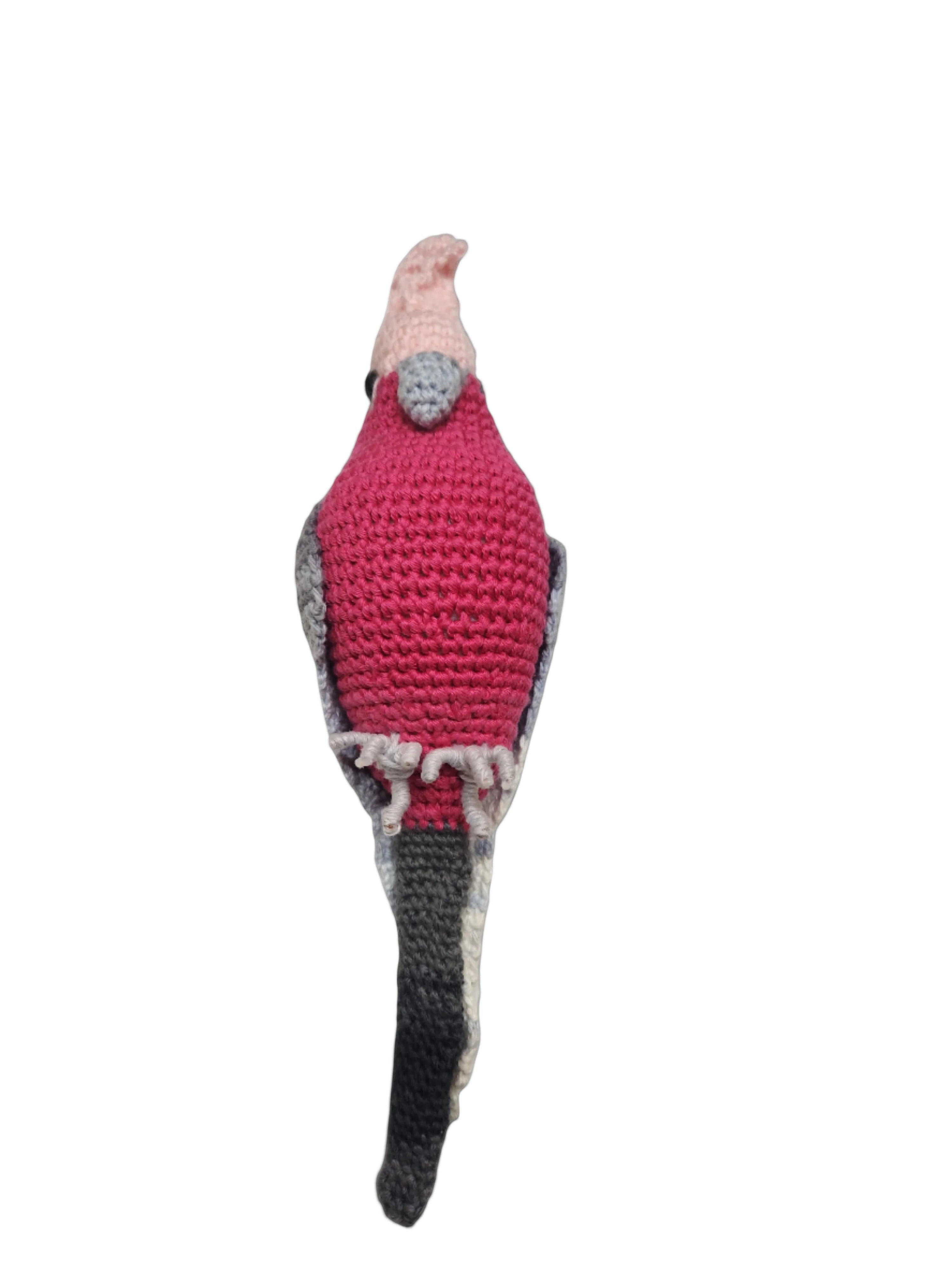 Suzie's Sunshine Dolls Galah crocheted bird with pink head, grey accents, and a magenta body. Wire feet.