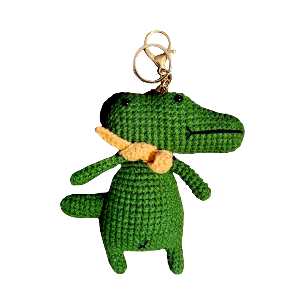 Suzie's Sunshine Dolls green crochet alligator keychain with orange scarf and gold keyring.
