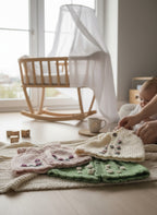 Suzie's Sunshine Dolls: Hand-knitted 100% wool doll outfits in pink, cream, and green with floral embroidery.