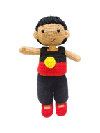 Suzie's Sunshine Dolls Coen, a crochet Indigenous Australian doll with short black hair, wearing red, black, and yellow outfit.