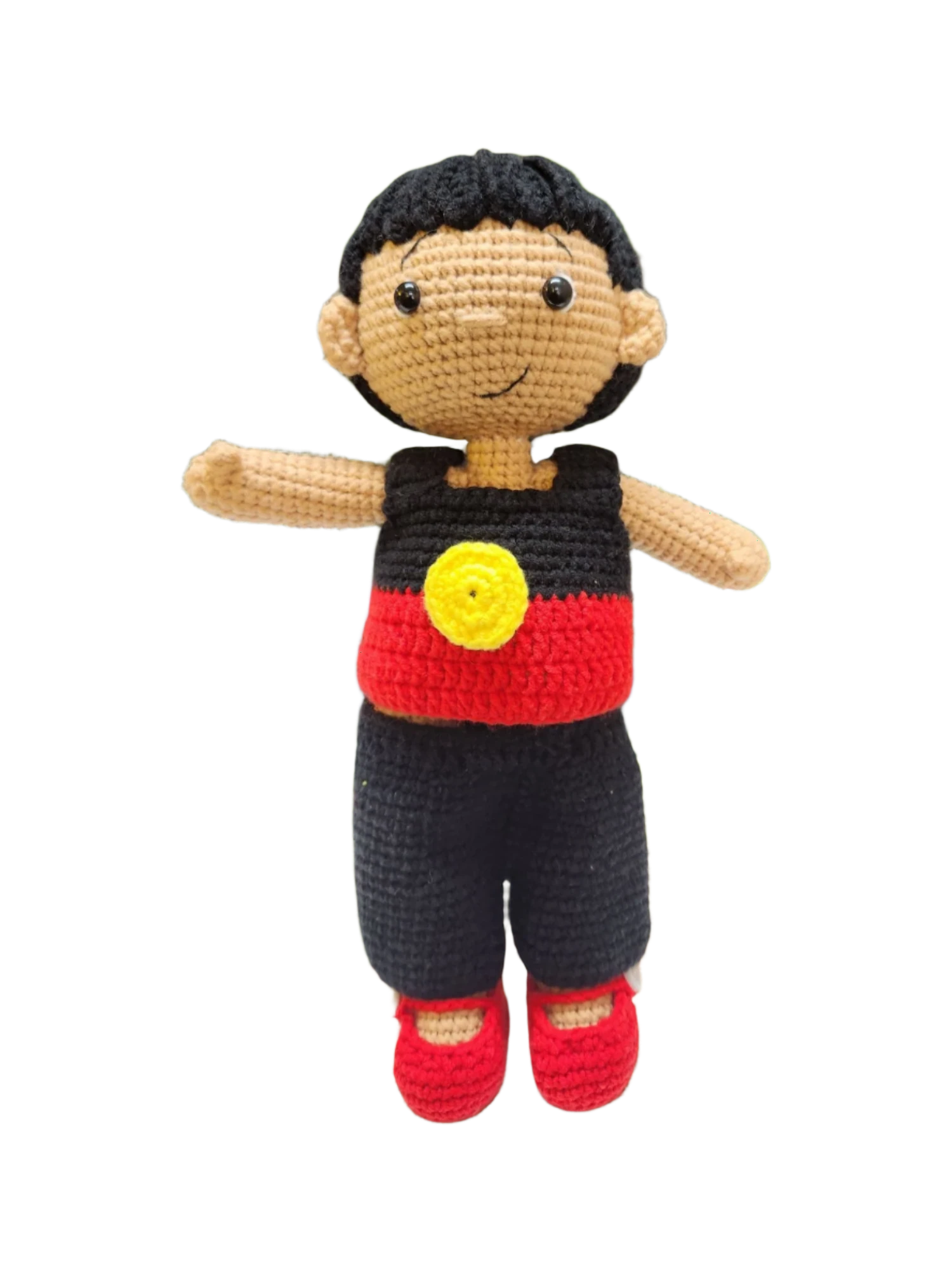 Suzie's Sunshine Dolls Coen, a crochet Indigenous Australian doll with short black hair, wearing red, black, and yellow outfit.