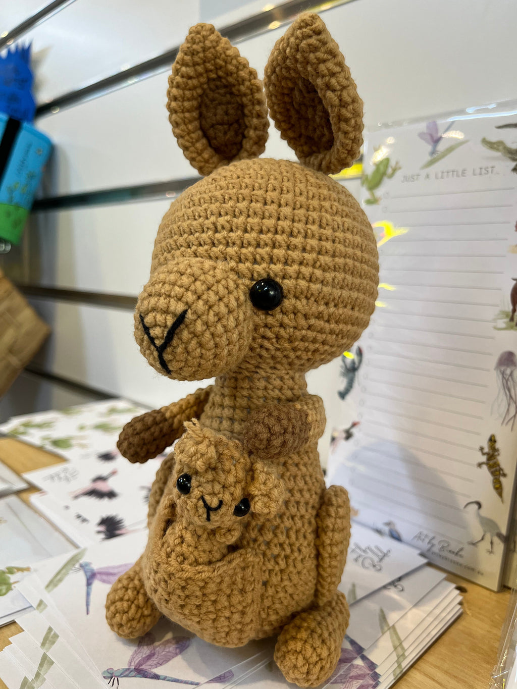 Suzie's Sunshine Dolls Kirsty the Kangaroo, a handmade brown crochet toy with joey in pouch. Approx 22-25cm.