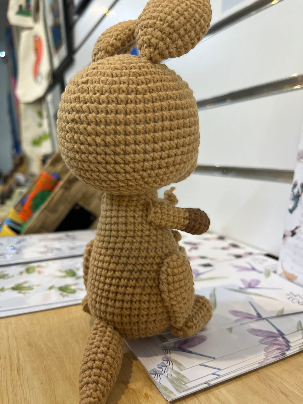Suzie's Sunshine Dolls Kirsty the Kangaroo, a handmade brown crochet toy with a joey in her pouch. Approx 22-25cm.