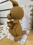 Suzie's Sunshine Dolls Kirsty the Kangaroo, a handmade brown yarn toy with a joey in her pouch. Approx 22-25cm.