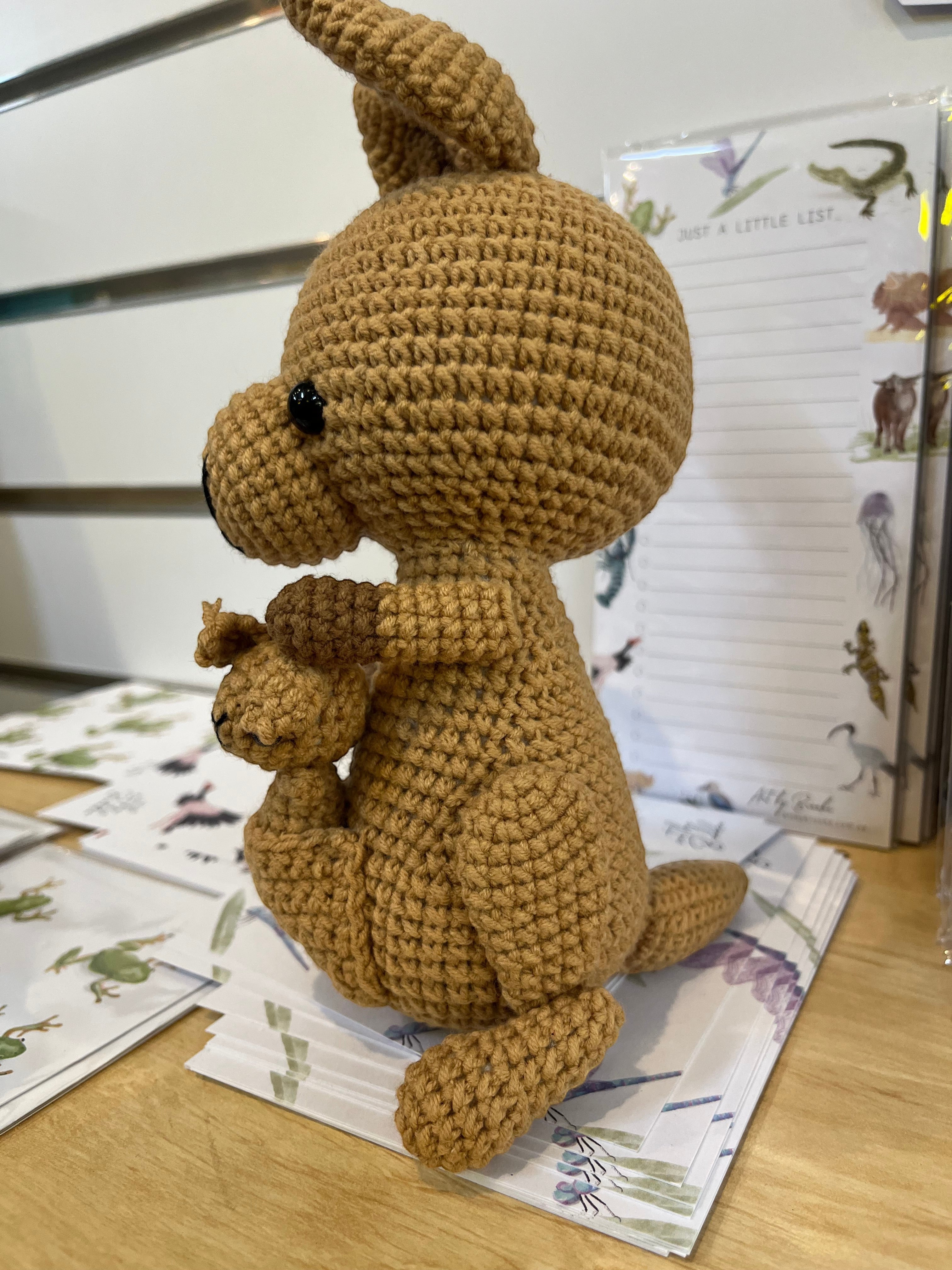 Suzie's Sunshine Dolls Kirsty the Kangaroo, a handmade brown yarn toy with a joey in her pouch. Approx 22-25cm.