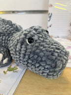 Suzie's Sunshine Dolls Kurtis the Croc, a handmade grey plush crocodile toy with stitched smile and white toes.