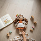 Suzie's Sunshine Dolls Little Miss Cherry Pie handmade crochet doll with brown curls, apron, and cherry hat.