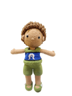 Suzie's Sunshine Dolls Malakai, a crocheted doll with short brown hair, wearing green shorts and a blue top with a white Dhari symbol.