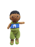 Suzie's Sunshine Dolls Malakai, a crocheted Torres Strait Islander doll with short black hair and a green outfit inspired by the flag.