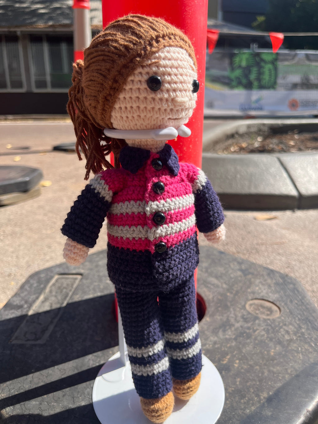 Suzie's Sunshine Dolls Miner/Tradie doll in pink hi-vis, navy pants, and brown boots. Handcrafted crochet.