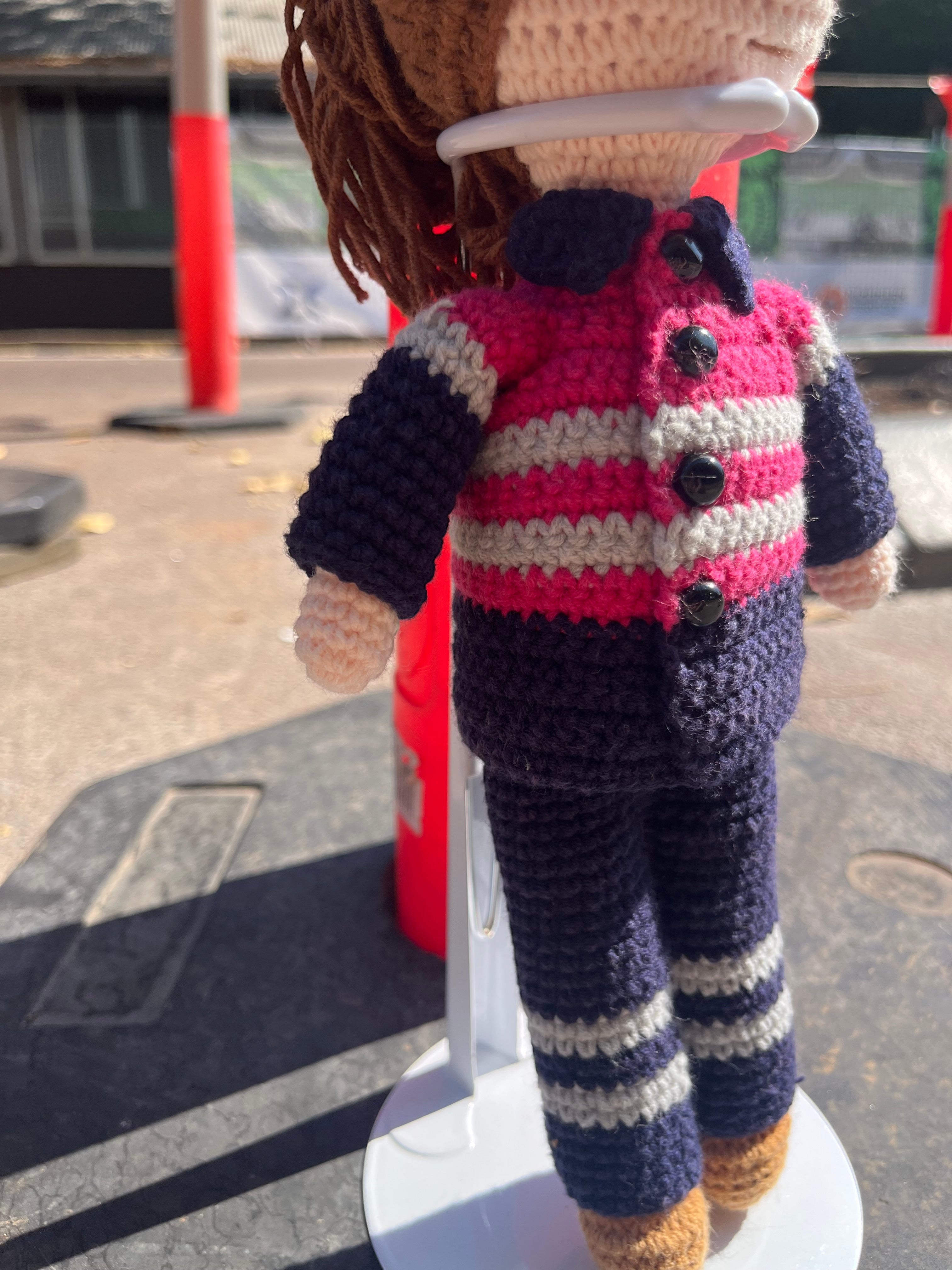 Suzie's Sunshine Dolls Miner/Tradie doll in pink hi-vis, navy pants, and striped jacket. Handmade crochet.