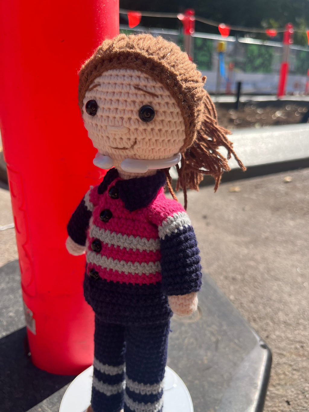 Suzie's Sunshine Dolls Miner/Tradie doll in pink hi-vis, navy pants, and striped sleeves. Handcrafted crochet toy.