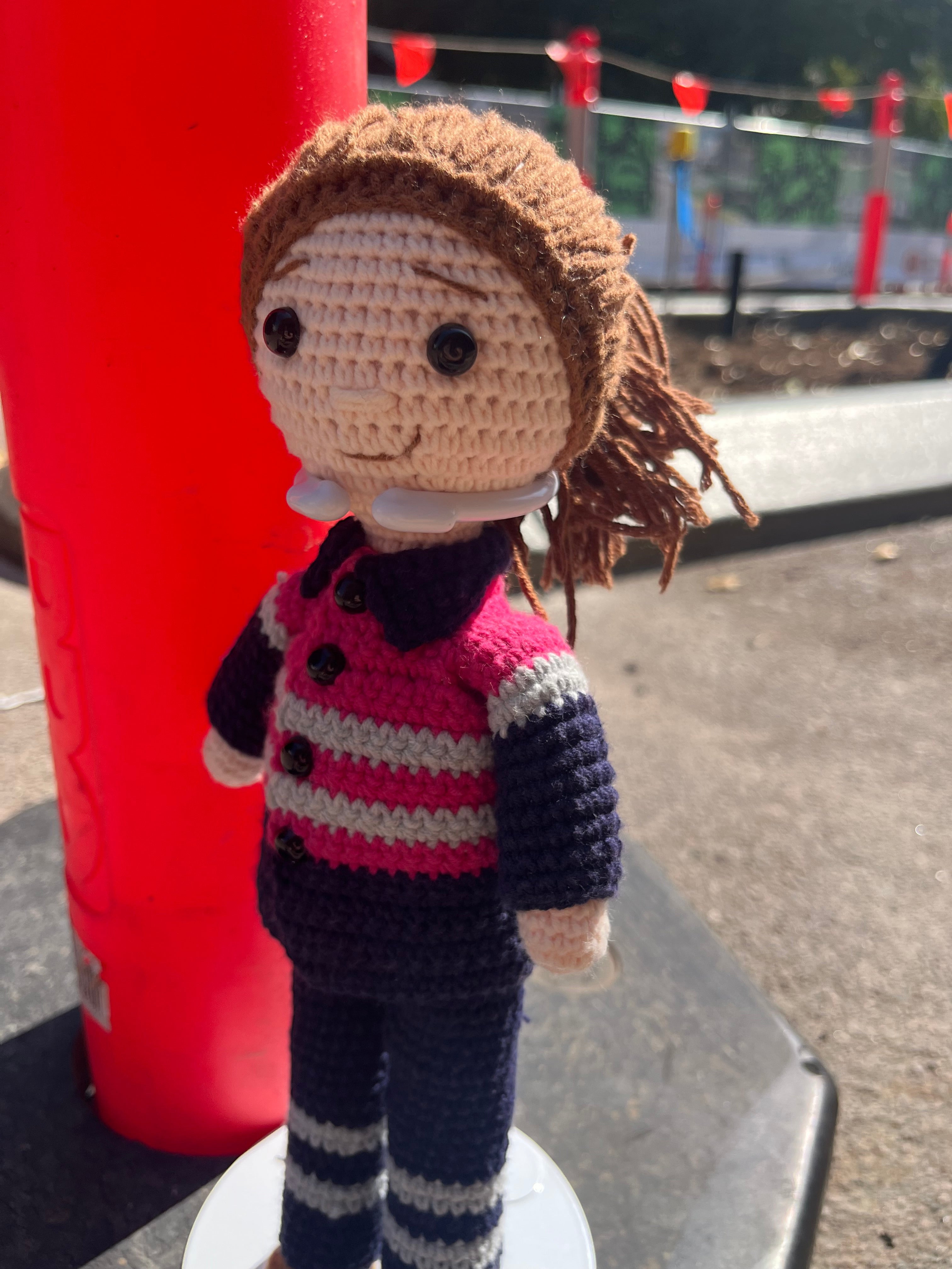 Suzie's Sunshine Dolls Miner/Tradie doll in pink hi-vis, navy pants, and striped sleeves. Handcrafted crochet toy.