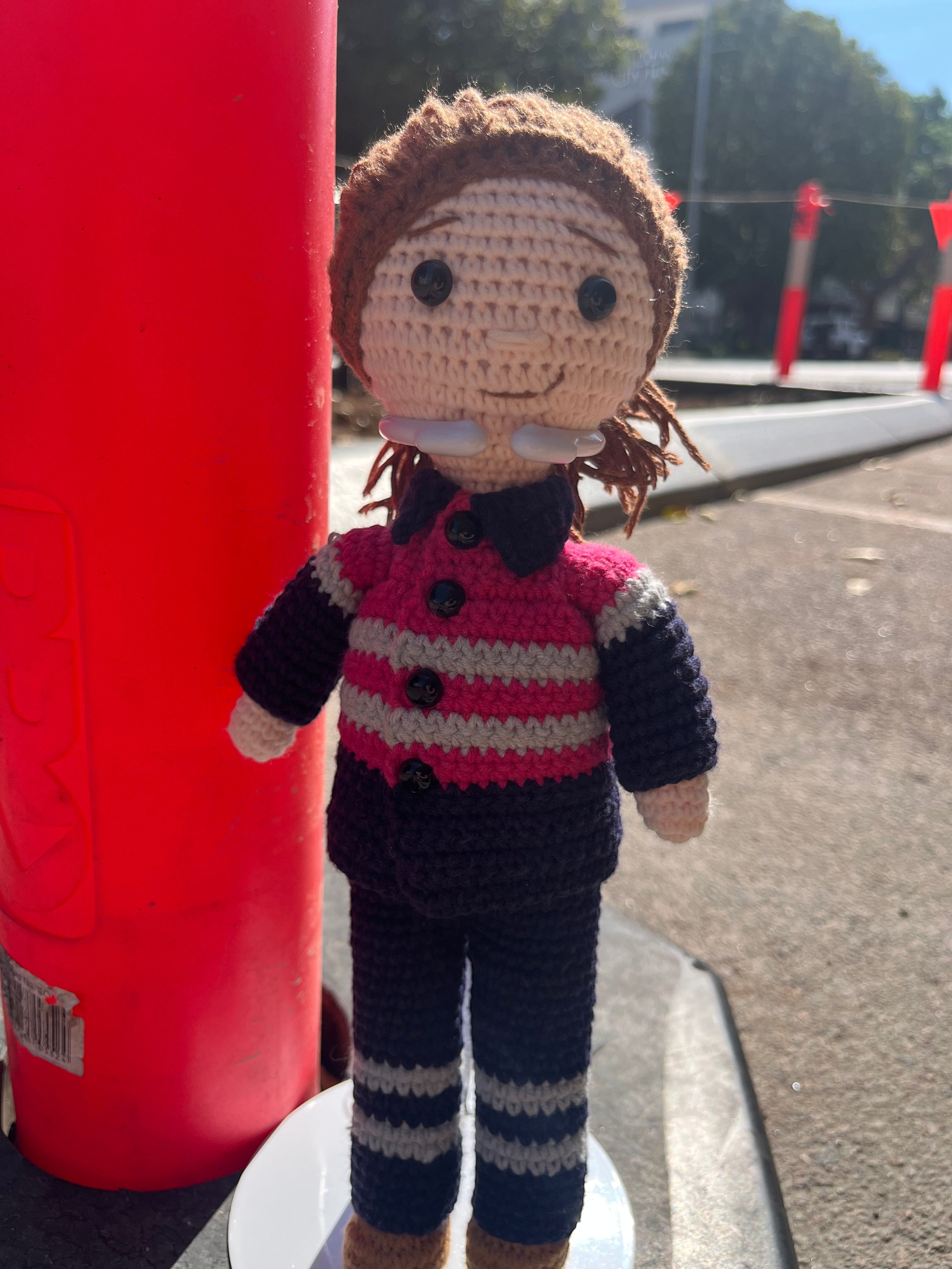 Suzie's Sunshine Dolls Miner/Tradie doll in pink hi-vis, navy pants, and brown boots. Hand-crocheted.