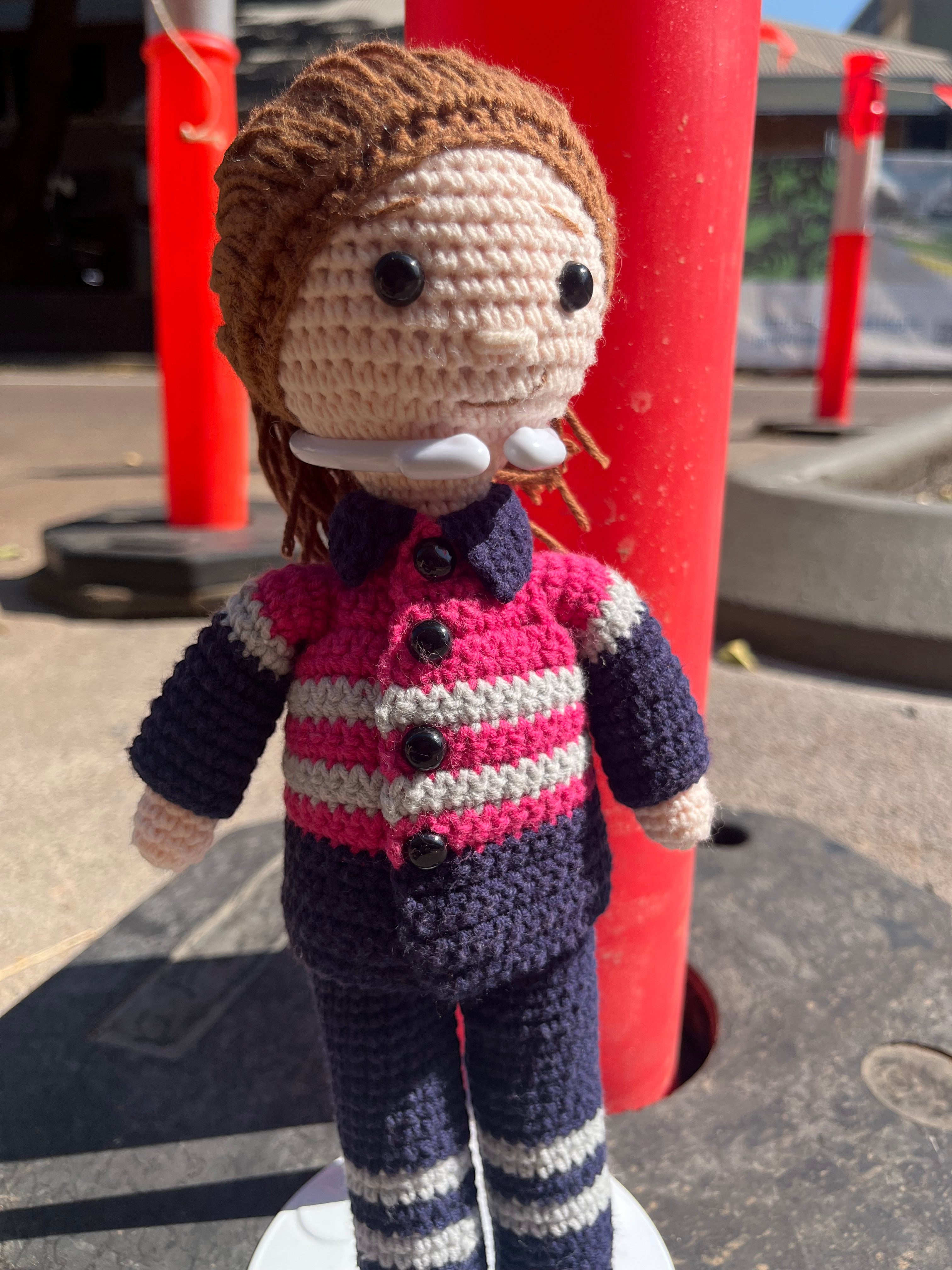 Suzie's Sunshine Dolls Miner/Tradie doll in pink hi-vis, navy pants, and striped shirt. Handmade crochet.