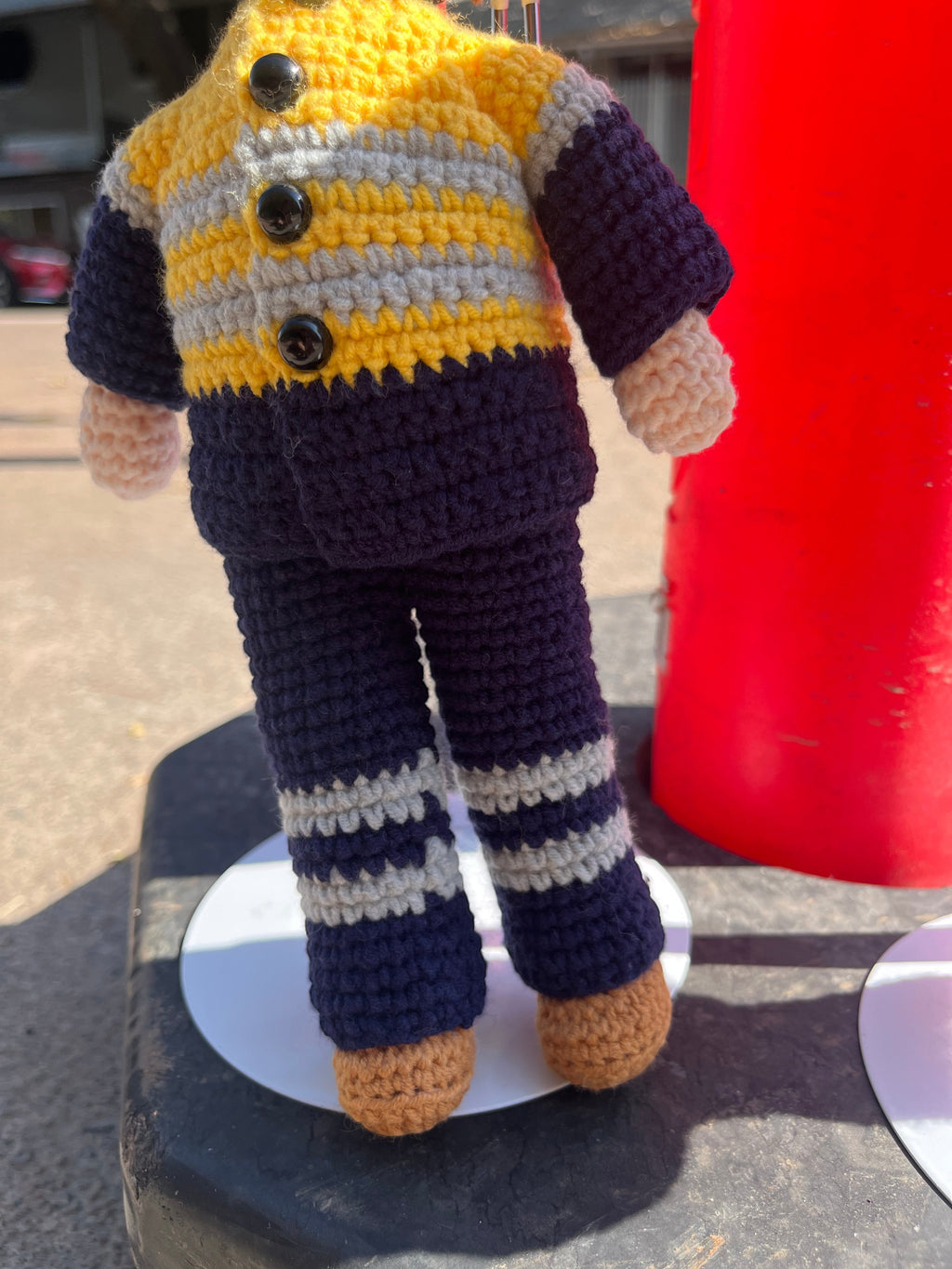 Suzie's Sunshine Dolls Miner/Tradie doll in yellow hi-vis, navy pants, and brown boots. Crocheted by hand.