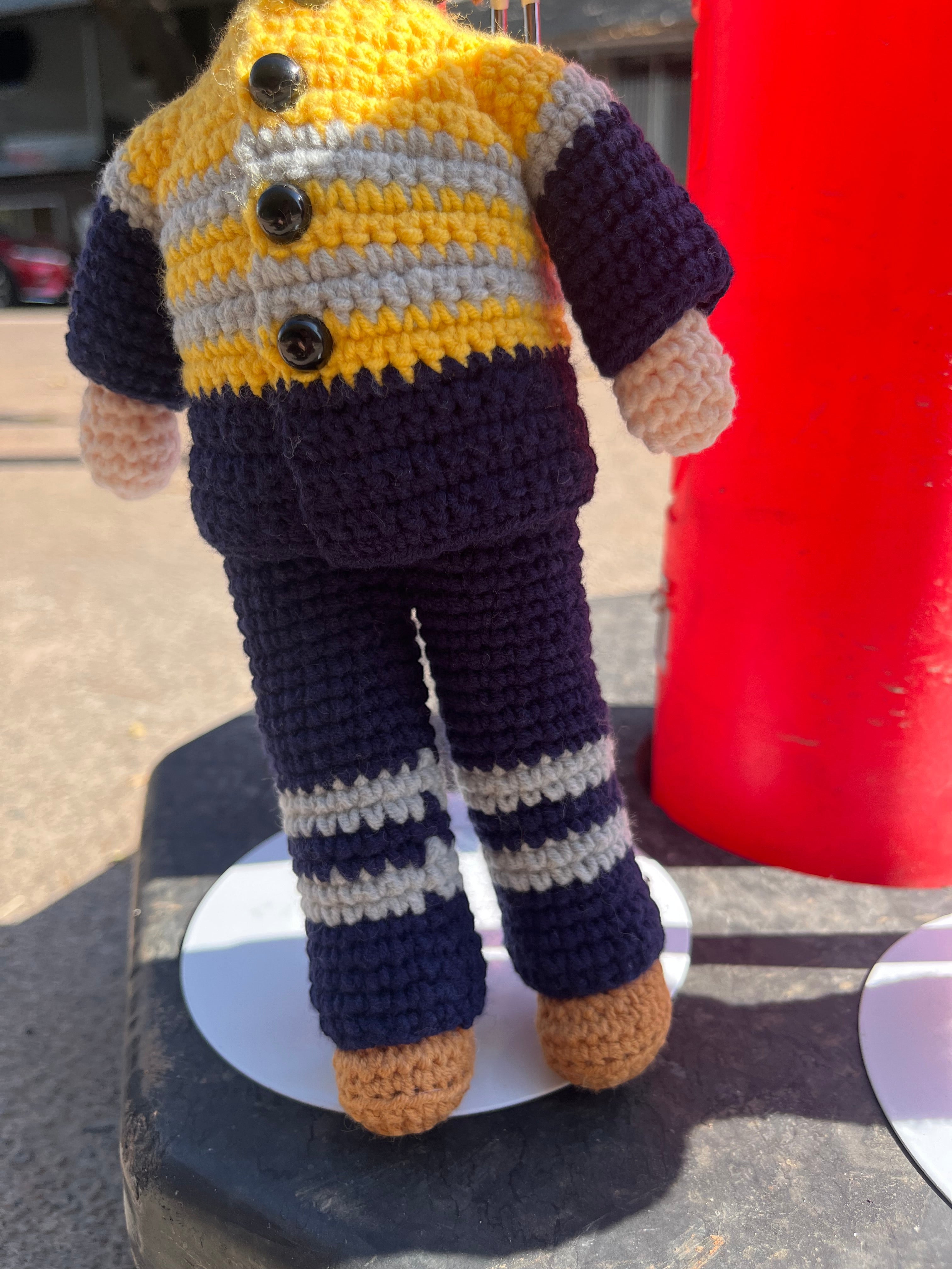 Suzie's Sunshine Dolls Miner/Tradie doll in yellow hi-vis, navy pants, and brown boots. Crocheted by hand.