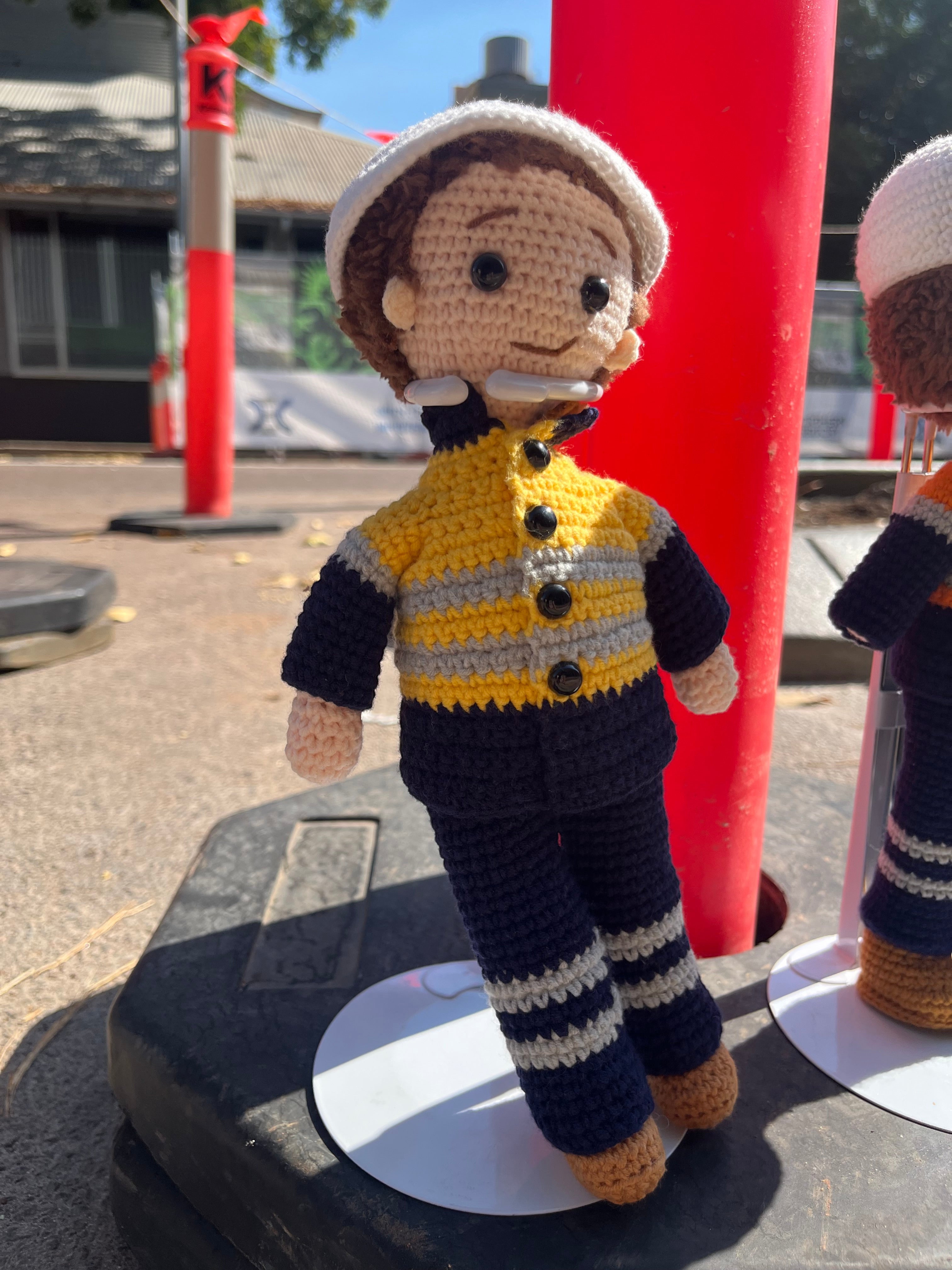 Suzie's Sunshine Dolls handmade crocheted miner/tradie doll in yellow hi-vis jacket and navy pants.