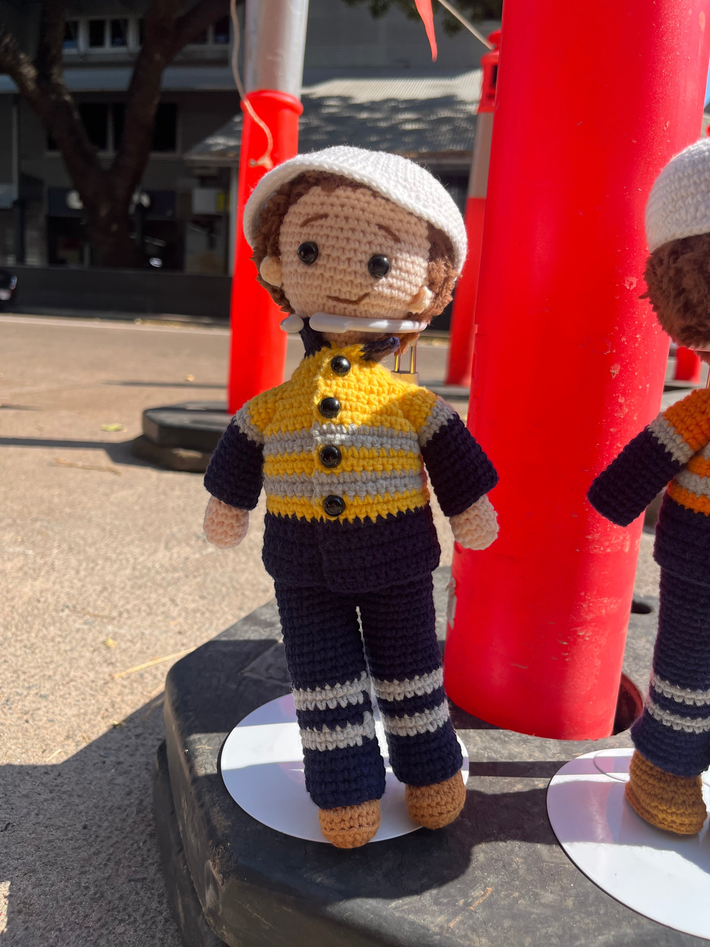 Suzie's Sunshine Dolls Miner/Tradie doll in yellow hi-vis jacket and navy pants, crocheted by hand.