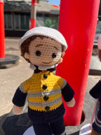 Suzie's Sunshine Dolls handmade crocheted doll dressed as a miner/tradie in yellow hi-vis jacket and navy pants.
