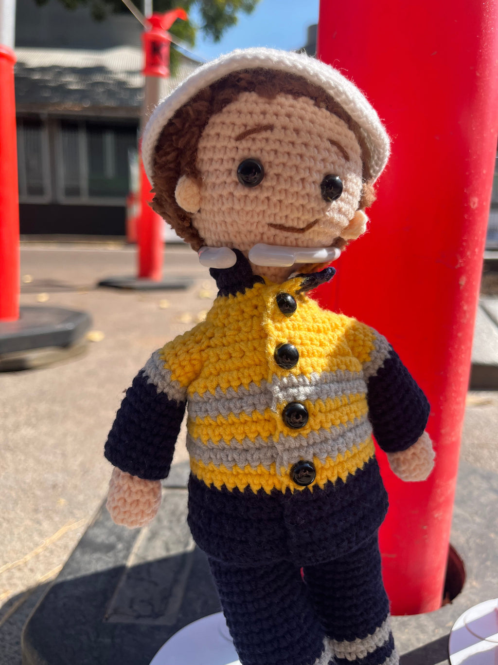 Suzie's Sunshine Dolls Miner/Tradie doll in yellow hi-vis jacket and navy pants, crocheted by hand.