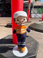 Suzie's Sunshine Dolls Orange Hi-Vis Miner/Tradie doll, crocheted with navy, orange, and grey stripes, wearing a white hard hat.