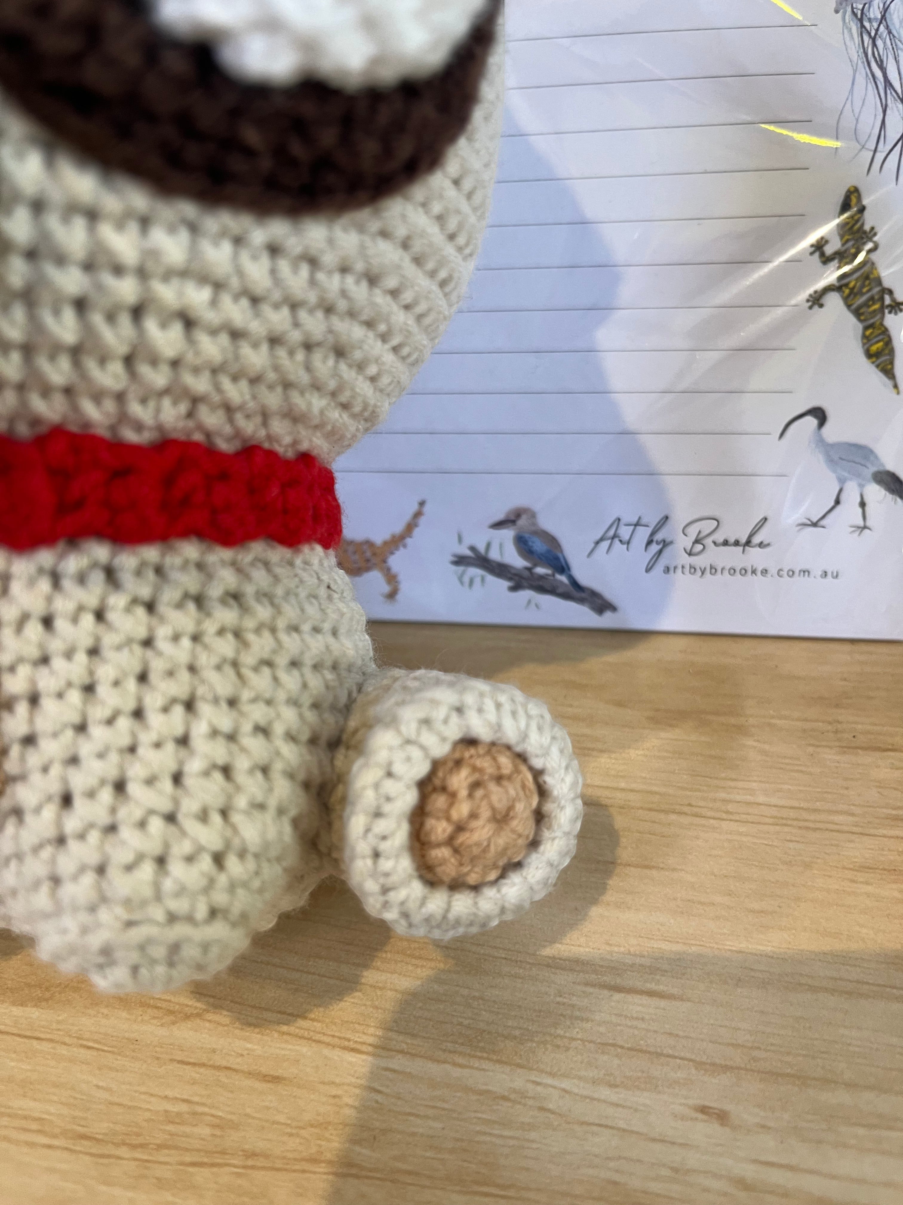 Suzie's Sunshine Dolls Pig the Pug crochet toy, cream body with red collar and brown ears.