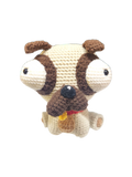 Suzie's Sunshine Dolls Pig the Pug crochet toy with big eyes, brown ears, and tongue out.