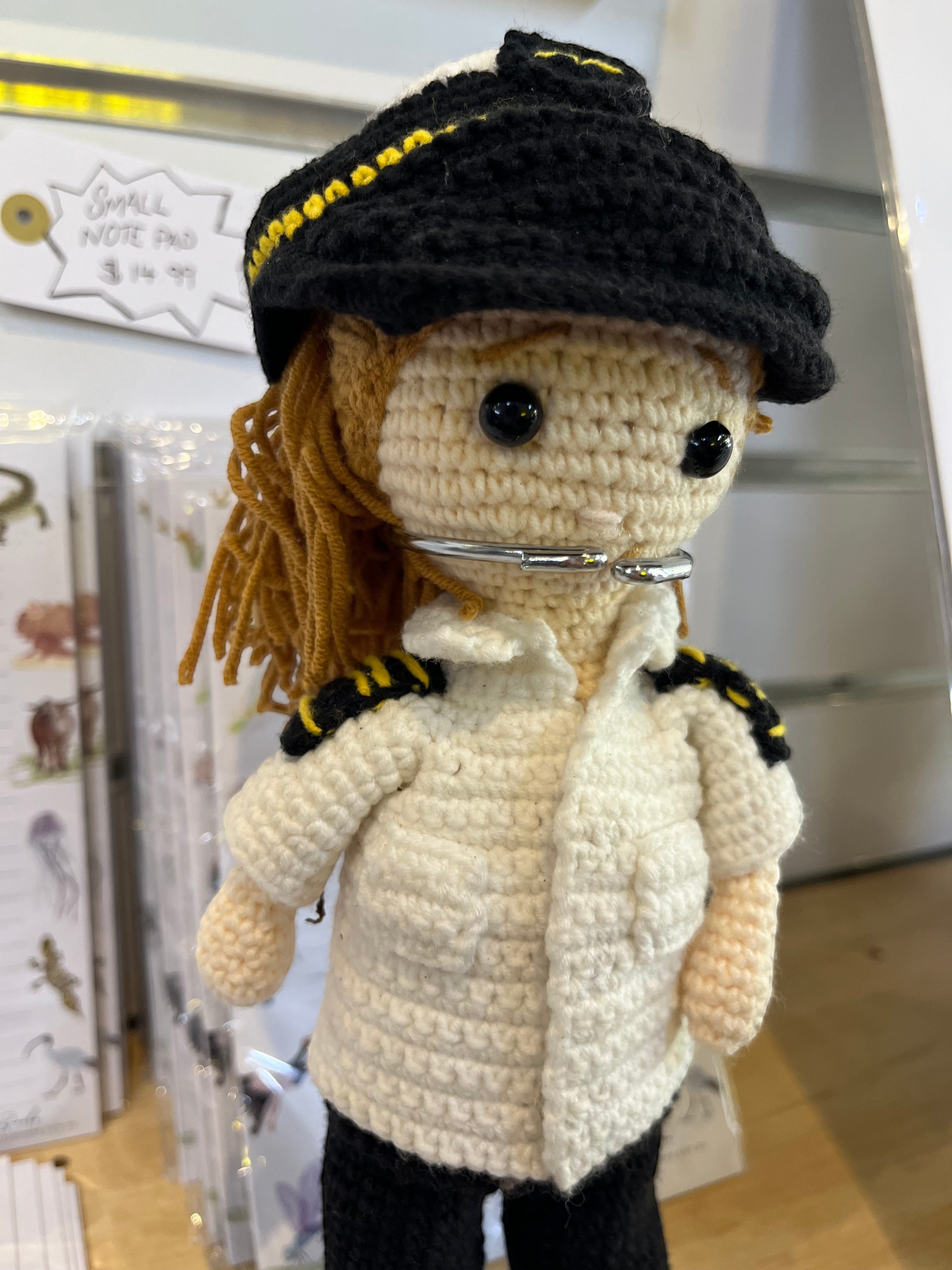 Suzie's Sunshine Dolls handmade crochet pilot doll in uniform with yellow stripes and black hat. Approx. 28-30cm tall.