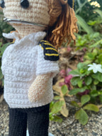 Suzie's Sunshine Dolls handmade crochet pilot doll in white shirt with yellow stripes and black pants.